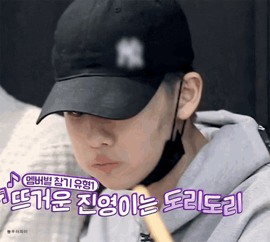 a close up of a person wearing a baseball cap with the letter n on it