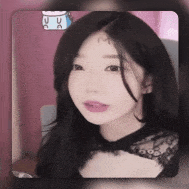 a girl with a letter m on her forehead is looking at the camera