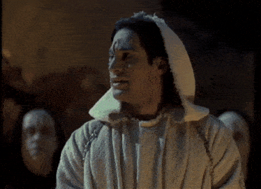 a man in a white robe is talking about the cities of earth