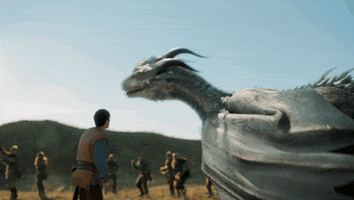 a man standing in front of a large dragon
