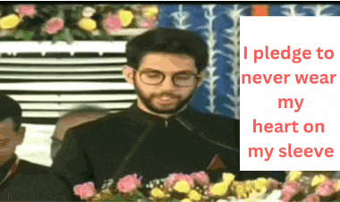 a man wearing glasses stands in front of a microphone and a sign that says i pledge to never wear my heart on
