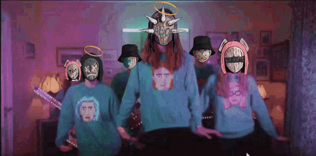 a group of people wearing sweatshirts with faces on them including one that says ' i 'm sorry '