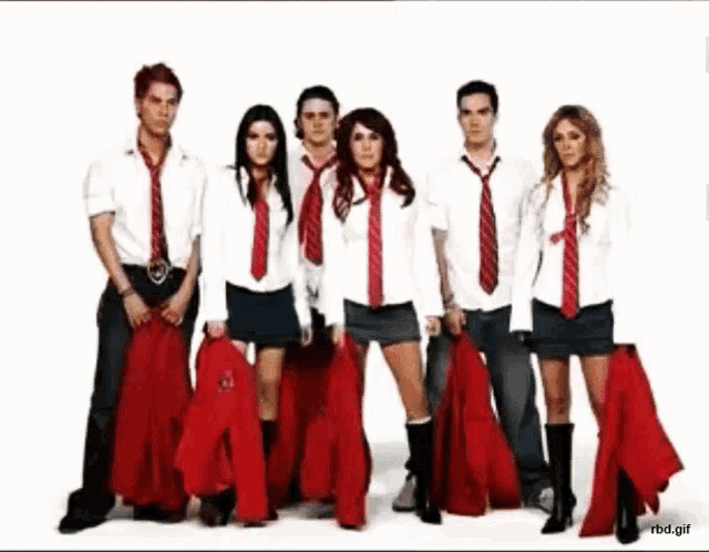 a group of people standing next to each other wearing red ties