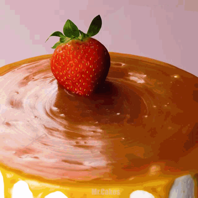 a strawberry is on top of a cake that says mr. cakes