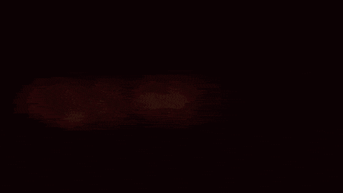 a blurred image of a red object in the dark