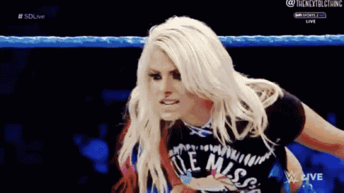 a woman in a wrestling ring wearing a shirt that says ole miss on it