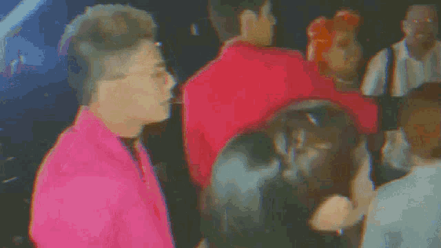 a blurry picture of a group of people dancing in a dark room