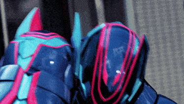 a close up of a robot 's helmet with a red stripe