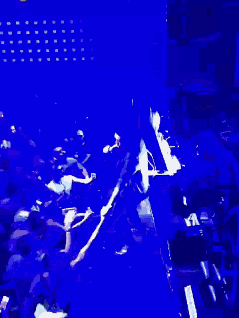 a crowd of people are watching a man on stage