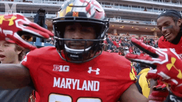 a maryland football player wearing a red jersey