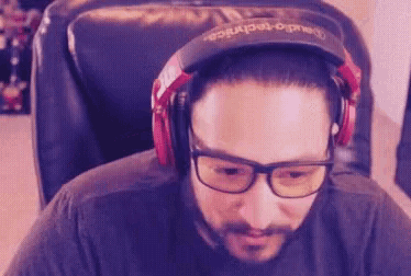 a man wearing headphones and a hat that says audio technica on it