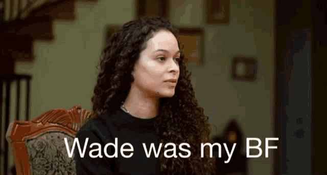 a woman with curly hair is sitting in a chair with wade was my bf written on the bottom