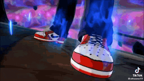 a person wearing a pair of red , white and blue sneakers .