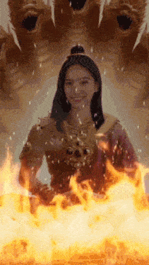a woman is surrounded by flames in front of a dragon