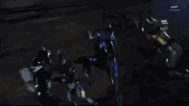 a couple of robots are fighting each other in a dark room .