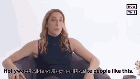 a woman in a black tank top is sitting in a chair and talking about hollywood wishes they could write people like this .