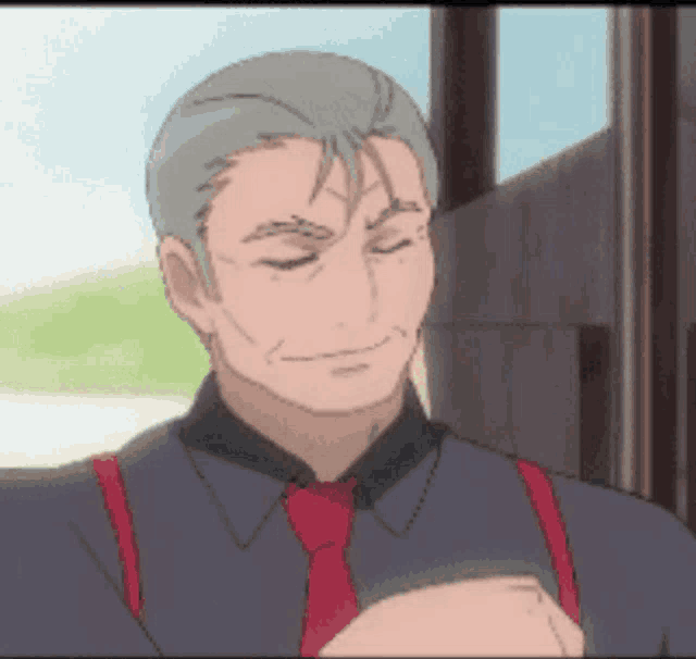 a man with gray hair and a red tie is smiling