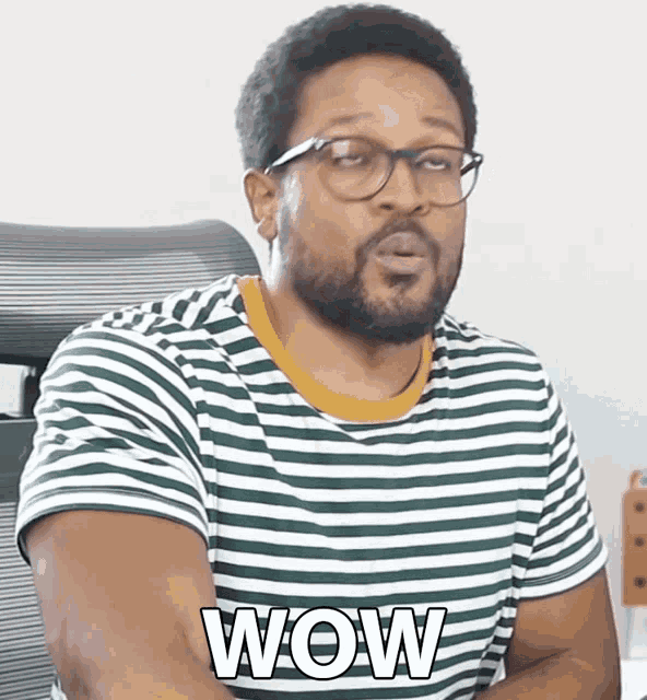 a man wearing glasses and a striped shirt with the word wow on it