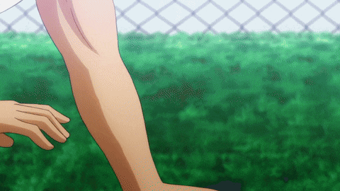 a close up of a person 's arm with a chain link fence in the background