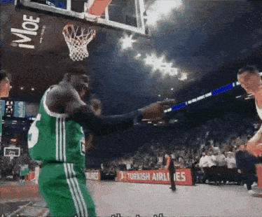 a basketball game is being played in front of a turkish airlines advertisement