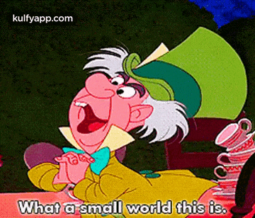 mad hatter from alice in wonderland is sitting at a table with a stack of teacups .