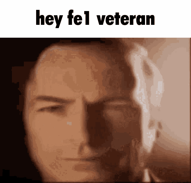 a close up of a man 's face with the words hey fel veteran written above it