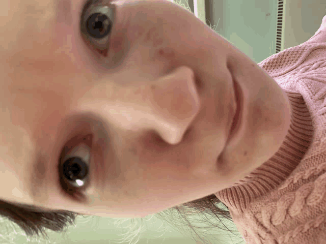 a close up of a woman 's face with her eyes closed