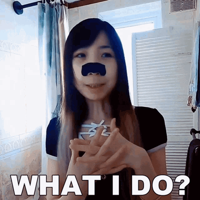 a woman with a black nose has the words what i do on her face