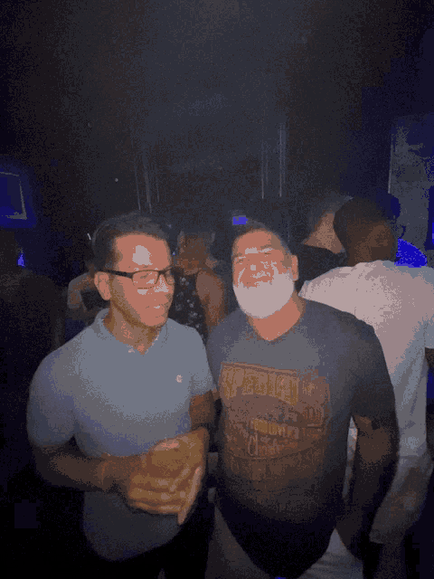 a man wearing a shirt that says ' abercrombie & fitch ' on it holds a drink