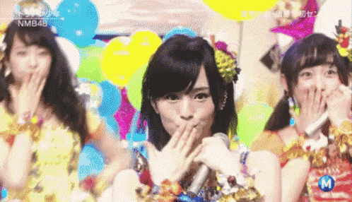 nmb48 is written on the bottom of a picture of three girls
