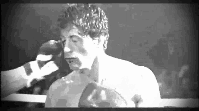 a black and white photo of a boxer with the number 44 on his gloves