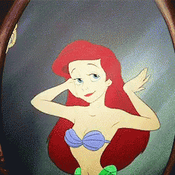 the little mermaid ariel is looking at herself in the mirror