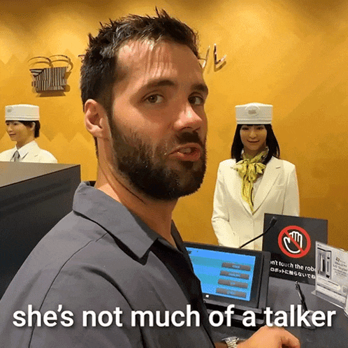 a man with the words she 's not much of a talker on his shirt