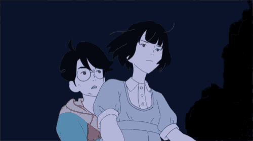 a boy and a girl are standing next to each other in the dark