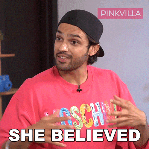 a man wearing a pink shirt that says moschino on it
