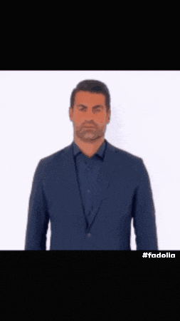 a man in a suit is making a funny face