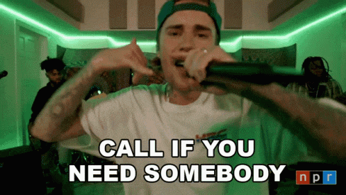 justin bieber singing into a microphone with the words call if you need somebody npr