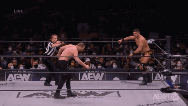 two men in a wrestling ring with the word aew on the bottom