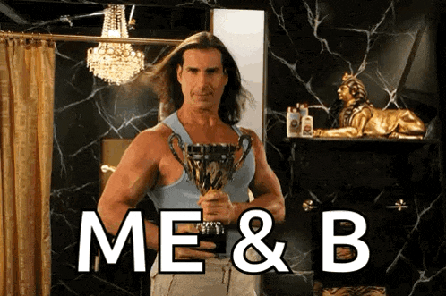 a man holding a trophy with the words me & b written on it