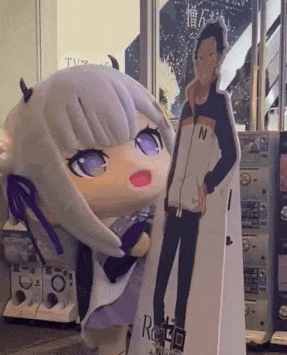 a cardboard cutout of a girl with horns and a man with the letter n on his jacket