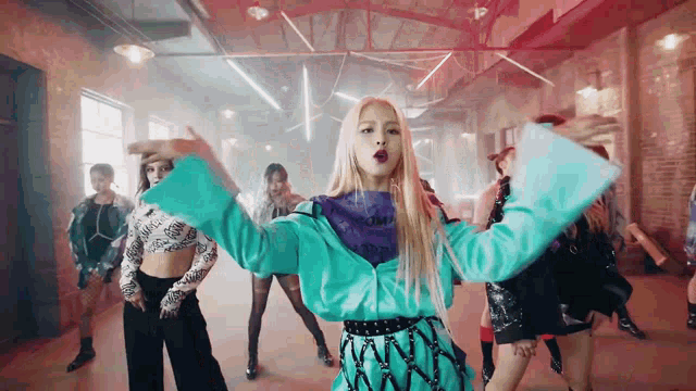 a group of young women are dancing together in a room .
