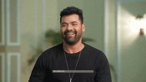 a man with a beard wearing a black shirt is smiling with a loading bar above his head