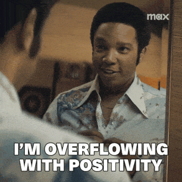 a man is looking at himself in the mirror and says i 'm overflowing with positivity