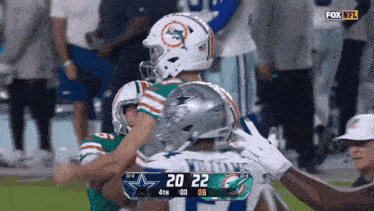a football game between the cowboys and the dolphins is being shown on fox nfl