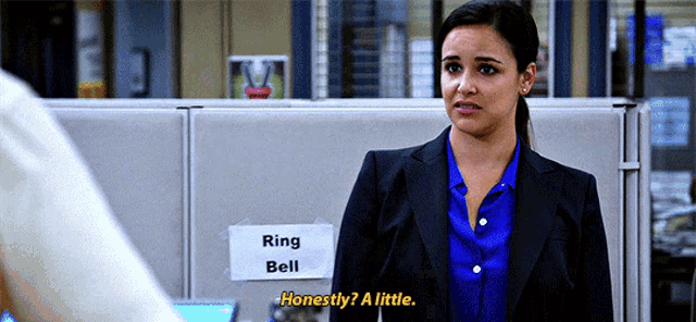 a woman is standing in front of a sign that says ring bell