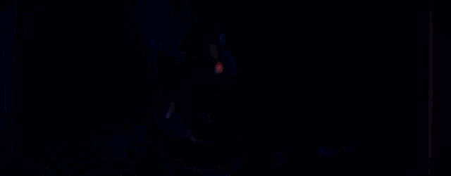 a close up of a person 's face in a dark room with a blue light behind them .