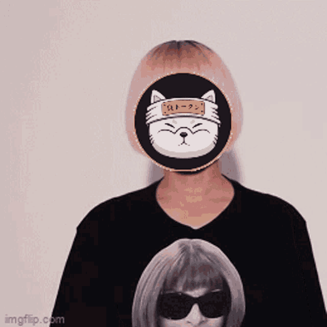 a person wearing a black shirt with a cat on their face