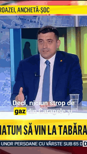 a man in a suit and tie is talking on a television show