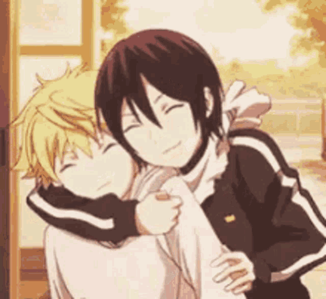 a boy and a girl are hugging each other in a room .