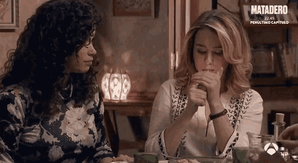 two women sitting at a table with matadero written on the bottom right